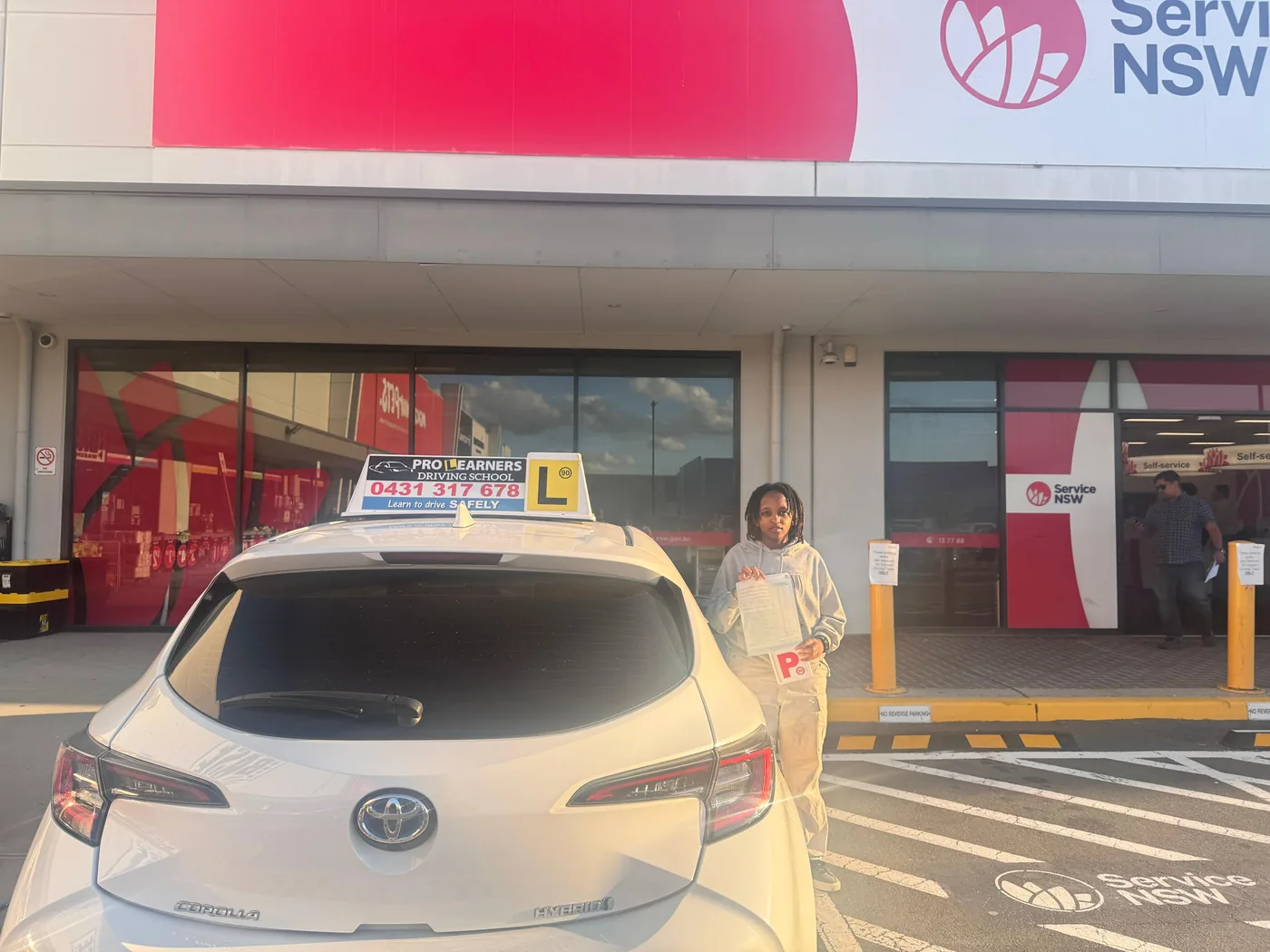 Pro Learners student holding P-plate after passing driving test